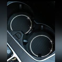 two speakers in the center console of a car with diamond trimmings on them