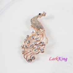 "LarkKing BH93 Peacock brooch, crystal peacock brooch, pearl peacock brooch, rhinestone peacock brooch, women gift, birthday gift. Material: brass metal, rhinestone crystals, pearl Size: 2 3/4\"x 1 3/8\" (width x height) Weight: 15.1 g (0.53OZ) Gift box is available at https://www.etsy.com/your/shops/LarkKing/tools/listings/section:22684027 LarkKing Sweet and sleek! All that jewelry. Meet the owner of LarkKing Learn more about the shop and process" Elegant Party Brooch With Peacock Design, Wedding Brooch With Peacock Design, Elegant Wedding Brooch With Peacock Design, Elegant Peacock Design Brooch For Wedding, Elegant Peacock Design Wedding Brooch, Peacock Colored Wedding Brooch Jewelry, Elegant Peacock-colored Brooches For Wedding, Gold Brooches With Peacock Design As Gift, Elegant Peacock Brooches For Wedding