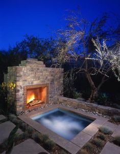 an outdoor fire pit in the middle of a yard at night with text overlay reading most up - to - date photo fir