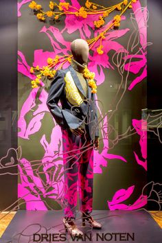 a mannequin dressed in a suit with flowers on it