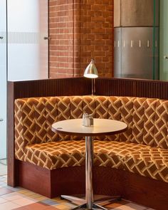 a corner booth with a table and chairs