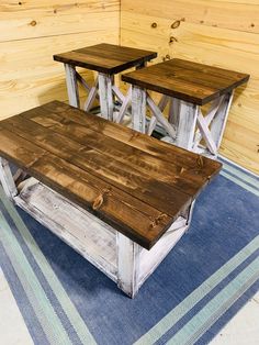 two wooden tables sitting on top of a blue rug