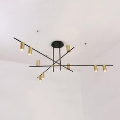 a chandelier hanging from the ceiling in a room with white walls and flooring