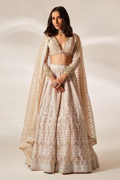 Peach attached cancan lehenga with intricate chikankari, sequin embroidery in floral pattern. Paired with embroidered full sleeve padded blouse and checkered embroidered dupatta.
Components: 3
Pattern: Embroidery
Type Of Work: Chikankari, sequin
Neckline: Plunge V neck
Sleeve Type: Full sleeves
Fabric: Organza
Color: Peach
Other Details: 
Attached inner lining
Lehenga:
Attached cancan
Floral pattern
Length: Approx. 43 - 47 inches
Weight: 3.5 kgs
Closure: Drawstring with zipper and hooks
Blouse: V Neck Full Sleeve Blouse, Chikankari Lehenga Designs, Full Sleeves Lehenga, Chikankari Lehenga Bridal, White Chikankari Lehenga, Long Sleeve Lehenga With Sheer Dupatta, Full Sleeve Lehenga, Floral Indian Outfit, Fitted Wedding Lehenga With Chikankari Embroidery