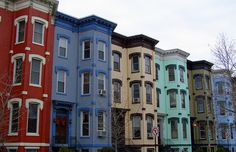 a row of multi - colored houses in the city