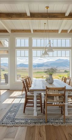 the dining room table is surrounded by wooden chairs and an area rug that matches with the hardwood flooring