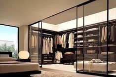 a walk in closet filled with lots of clothes