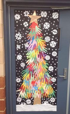 a door decorated with christmas trees and snowflakes