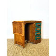 an old wooden desk with two drawers on it's sides and one drawer open