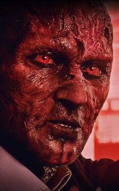 a man with red eyes and blood on his face