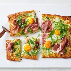 four square pizzas topped with ham, cheese and an egg