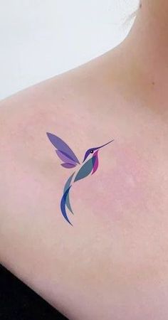 a small hummingbird tattoo on the back of a woman's left upper arm