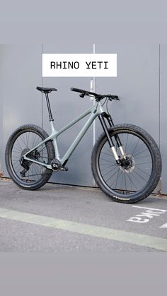 a bike parked next to a wall with the words rhino yeti on it