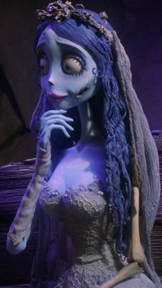 the corpse girl is dressed up in her wedding dress and makeup, with long blue hair