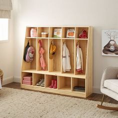 a child's room with a rocking chair, bookshelf and various items