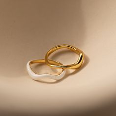 Our Duo Wave Ring Set gives you the perfect combination of minimalist and groovy. The wavy and unique design of these rings are easy to pair with other jewelry pieces in your collection. Add them to your everyday lineup to add dimension while not compromising the effortlessness of your look. Material: High Quality Solid 925 Sterling Silver Finish: 18K Gold ∙ White Enamel Featuring a Set of 2 Wavy Rings: Each with band widths ranging from ~1.5mm to ~3.5mm Model showcases a unique, groovy look fea Cool Ring Designs, Caitlyn Minimalist, Initial Tag Necklace, Dainty Initial Necklace, Stacking Ring Set, Wave Ring, 18k Gold Ring, Birthstone Gifts, Ring Sizer