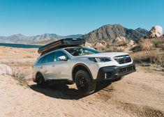 a white subarunt is parked in the desert