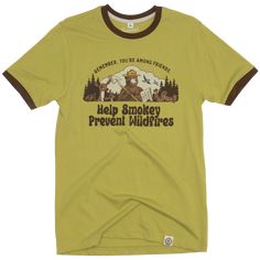 Need something to wear next time you're among friends? We've got you covered. This Smokey Bear t-shirt takes inspiration from vintage styles with a powerful message. Designed with campy colors and contrasting ribbing, it's a stylish way to support Smokey's Legacy. Your friends, whether they're people or woodland creatures, are sure to agree. Retro Outdoor Graphic Print T-shirt, Retro Graphic Print T-shirt For Outdoor, Vintage Adventure Graphic T-shirt, Vintage T-shirt With Letter Print For Outdoor Activities, Vintage Short Sleeve T-shirt For Adventure, Vintage Graphic Print T-shirt For Adventure, Vintage Cotton Tops For Outdoor Activities, Vintage Outdoor T-shirt With Letter Print, Vintage Letter Print T-shirt For Outdoor