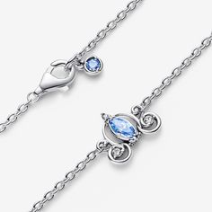 Follow the call of the ball with the Disney Cinderella's Carriage Collier Necklace from Disney x Pandora. This sterling silver necklace features an intricate pendant inspired by Cinderella's enchanted pumpkin carriage, with a blue marquise-shaped stone surrounded by swirling openwork details. Small cubic zirconia stones sparkle on the wheels and pumpkin stem. The pendant is fixed to the chain, and the necklace is adjustable to three lengths. Style it together with the matching stud earrings for an elevated Cinderella-inspired look. - Pandora Disney Cinderella's Carriage Collier Necklace - Sterling silver / Cubic Zirconia / Blue - Sz. 17.7 in Disney Sterling Silver Jewelry In Silver, Cinderella's Carriage, New Cinderella, Pumpkin Carriage, Pumpkin Stem, Pandora Disney, Blue Necklace, Necklace Sizes, Lab Created Diamonds