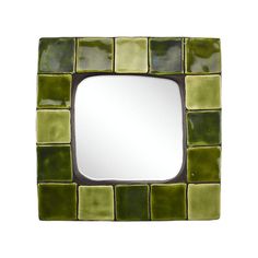 a square mirror with green tiles on it