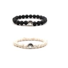 two bracelets with black and white beads, one has a lion head on it