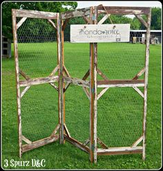 a wooden fence with a sign that says handcraftt on it in front of some grass