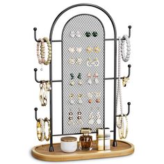 a jewelry rack with several necklaces and bracelets hanging from it's sides