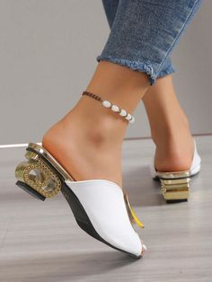 Elevate your style with our Chic Metal Embellished Sculptural Heeled Mule Sandals. Featuring a sleek and modern design, these sandals are adorned with metal embellishments that add a touch of sophistication. The sculptural heel offers both comfort and style, making these sandals the perfect choice for any occasion. Color : White Heel Height : Low Heel Upper Material : PU Leather Lining Material : PU Leather Insole Material : PU Leather Outsole Material : Rubber Gold Sandals With Metal Feet And Open Heel, Formal Sandals With Metal Feet, Formal Synthetic Sandals With Metal Feet, Chic High Heel Sandals With Metal Feet, Chic Gold Toe Post Sandals, Elegant Synthetic Toe Post Sandals, Elegant Toe Post Synthetic Sandals, White Open Toe Heels With Metal Feet, Elegant Embellished Toe Post Sandals