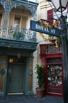 a street sign in front of a building with ornate balconies and balconyes