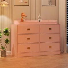 a baby's room with pink furniture and pictures on the wall, including a toy fox