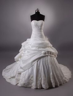 a white wedding dress on a mannequin with a black top and bottom layer