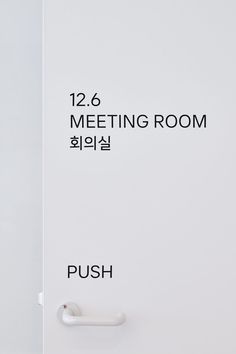 a white door with the words meeting room and push button