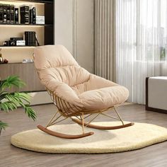 a living room with a rocking chair in the middle and a rug on the floor