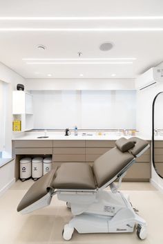 a modern medical room with an electric reclining chair