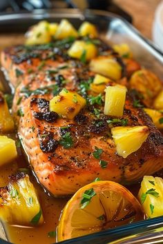 salmon with pineapples and potatoes in a glass casserole dish