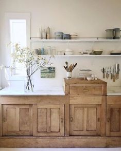 a kitchen with wooden cabinets and white walls