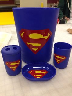 blue cups and plates with superman logo on them