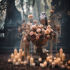 an owl sitting on top of a vase filled with flowers next to many lit candles