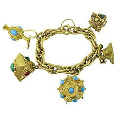 This is a fabulous 18k yellow gold charm bracelet. The bracelet features 5 pieces novelty charms in 18k yellow gold which are 3 lanterns, vintage phone and vintage pitcher. The charms are adorned with semi precious stone which are turquoise, malachite, jade and garnet. The bracelet measures 7 3/4 inches in length and weighs 76.7 grams. Inventory #91703WEBS Telephone Vintage, Vintage Phone, Vintage Phones, Vintage Charm Bracelet, Gold Charm Bracelet, Semi Precious Stone, Gold Charm, Charm Bracelets, Estate Jewelry