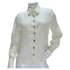 Elevate your wardrobe with the Chanel 90s White Linen Button Down Shirt – a classic and timeless piece that exudes sophistication. Crafted from lightweight ivory linen, this collared button-down shirt features silver-tone buttons adorned with Chanel logos, creating a subtle yet luxurious touch. The shirt's classic collar and breast pockets add a traditional charm, while the silver-tone buttons down the center and at the wrists showcase the iconic Chanel branding. The combination of crisp white l Chanel Branding, White Linen Button Down Shirt, Chanel 90s, Prada Sandals, White Linen Shirt, Chanel Logo, Button Down, Professional Look, Gucci Handbags