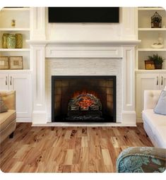 a living room with a fireplace, couch and television on the mantel above it