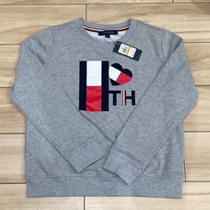 Tommy Hilfiger Gray Pullover Sweatshirt, Kids Size Small, New With Tags Tommy Hilfiger Letter Print Sweatshirt For Winter, Tommy Hilfiger Letter Print Winter Sweatshirt, Winter Tommy Hilfiger Sweatshirt With Letter Print, Tommy Hilfiger Cotton Crew Neck Hoodie, Tommy Hilfiger Sporty Letter Print Sweatshirt, Tommy Hilfiger Crew Neck Sweatshirt For Streetwear, Tommy Hilfiger Crew Neck Winter Sweatshirt, Tommy Hilfiger Casual Tops With Ribbed Cuffs, Casual Tommy Hilfiger Tops With Ribbed Cuffs