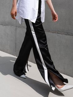 Midweight satin track trouser pants with side stripe in contract color. Straight leg with slight flare at bottom. Model is in MINUSEY S. ✔️ Free worldwide express shipping over $100✔️ Loved by 6,500+ customers✔️ Limited edition collections, maximum style⠀⠀⠀⠀⠀⠀⠀⠀⠀Stay ahead of the trend with can’t-find-anywhere-else staples. Your closet will thank you 💕* MINUSEY S = EU 34, US 2* MINUSEY M = EU 36, US 4* 100% Polyester* Dry clean* Made in Korea - Model Height: 172cm/5'7" (US2, EU34) Full Length Pants With Side Stripes, Black Full-length Pants With Side Slits, Black Wide Leg Pants With Side Slits, Black Satin Wide-leg Pants, Pants With Side Stripe, Black Sweatpants Outfit, Sweatpants Outfit, Stripe Outfits, Pants Outfits