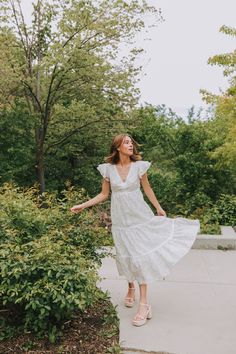 Get ready to turn heads in our EXCLUSIVE Move With Me Dress! With its unique floral pattern featuring yellow, sage, and lavender details, this midi dress is perfect for any occasion. The tiered design adds playful movement, while the double ruffle flutter sleeves and V-neck add a touch of femininity. The lace overlay on the neckline, chest, waistline, and hemline adds a flirty touch, while the elastic waist and side zipper provide a comfortable and flattering fit. Don't miss out on this one-of-a Tiered Midi Dress For Spring Garden Party, White Midi-length Tiered Dress For Garden Party, White Midi Length Tiered Dress For Garden Party, White Midi Tiered Dress For Garden Party, Spring Tiered Midi Dress For Garden Party, White Midi Length Tiered Dress For Spring, Casual Midi Length Tiered Dress For Garden Party, Flowy Tiered Dress For Garden Party In Spring, Floral Print Midi Length Tiered Dress For Spring