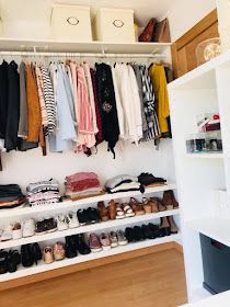 an organized closet with clothes and shoes