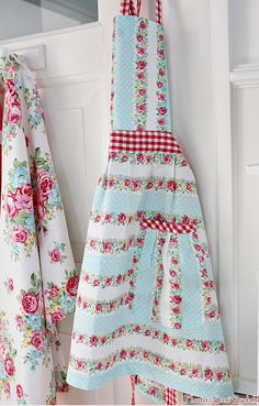 the aprons are hanging on the door