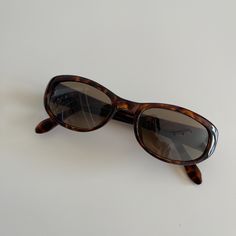 Authentic 1990s made vintage high quality frames paired with polyurethane lenses. One of a kind, rare discontinued frames with limited quantity.    Measurements: Frame width: 135mm Lens width: 51mm Lens height: 32mm Bridge: 18mm Arm temple: 140mm Shape: Rectangle  Lens : Brown Condition: New Deadstock  Lens: UV 400 High Quality Durable Style 010 Rayban Sunglasses For Women, Dapper Day Outfits, 90s Sunglasses, Sunglasses Brown, Brown Lens, Rectangle Sunglasses, Oval Sunglasses, Black Metal Frame, Tiaras And Crowns