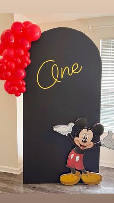 a mickey mouse themed birthday party with balloons