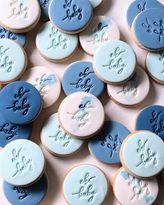 blue and pink decorated cookies with writing on them