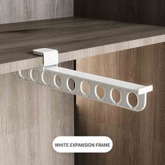 the white extension frame is attached to an oak cabinet with two circles on each side